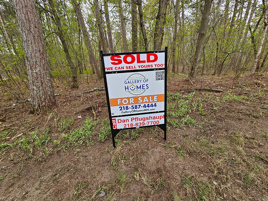 A home with a for sale sign in the yard