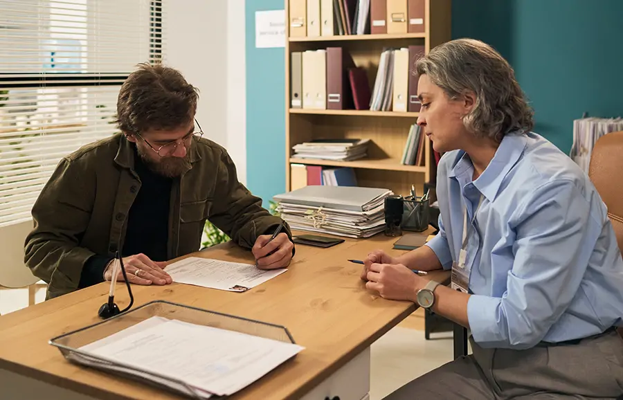 Signing final paperwork at a closing table
